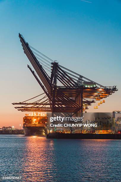 container ship loading at felixstowe port at dusk - felixstowe stock pictures, royalty-free photos & images