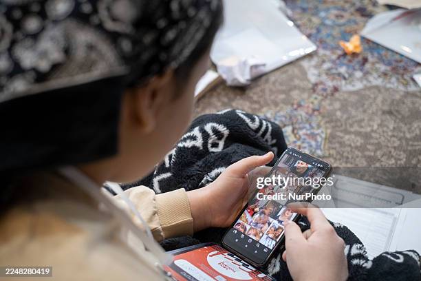 An Iranian girl uses an Iranian social media application on her cell phone while participating in the International Teenager Without Borders Festival...