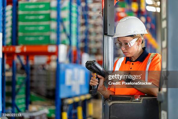 warehouse worker using barcode reader in warehouse. - shelf stocker stock pictures, royalty-free photos & images