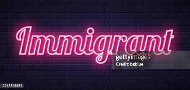 immigrant - glowing neon text on brick wall background - migrant worker stock illustrations