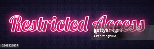 restricted access - glowing neon text on brick wall background - prohibited area stock illustrations