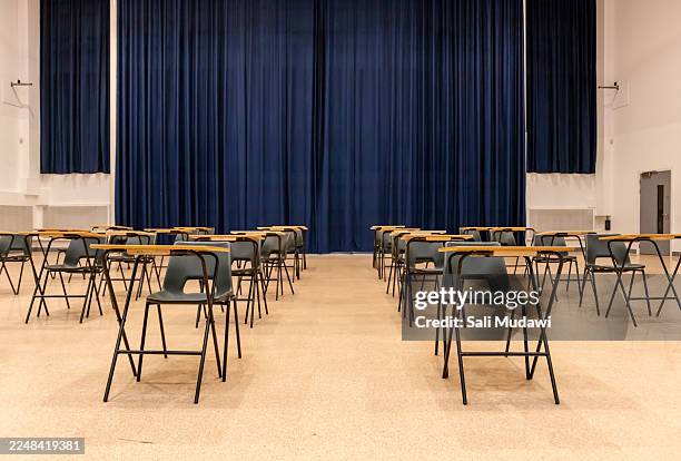 empty exam desks in school hall - exam hall stock pictures, royalty-free photos & images