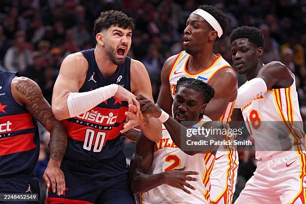 Tristan Vukcevic of the Washington Wizards and Keaton Wallace of the Atlanta Hawks get tangled up during the first half of an Emirates NBA Cup game...