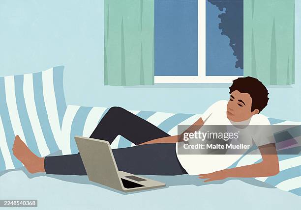 man relaxing at home on bed at night, using laptop - man using computer at home stock illustrations
