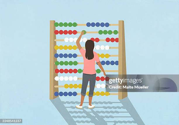 woman budgeting, adjusting beads on large abacus against blue background - haushaltskosten stock-grafiken, -clipart, -cartoons und -symbole