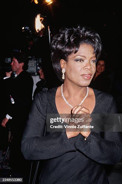 American talk show host Oprah Winfrey, wearing a black outfit with a scoop neck, attends the 2nd Annual Vanity Fair Oscar Party at Morton's...