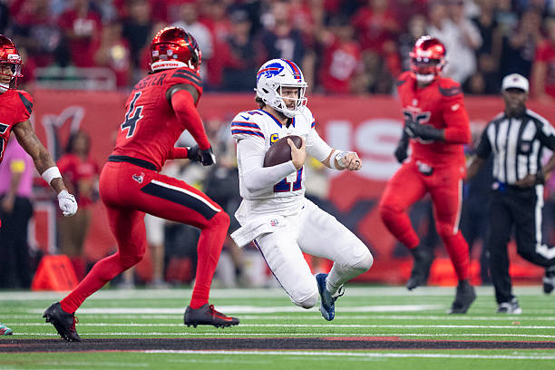 Josh Allen of the Buffalo Bills runs with the ball and slides during an NFL football game against the Houston Texans at NRG Stadium on November 20,...