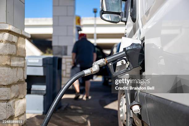 Gas pump is seen in a vehicle on November 26, 2025 in Austin, Texas. Gas prices are near their lowest in four years, with twenty-eight states...