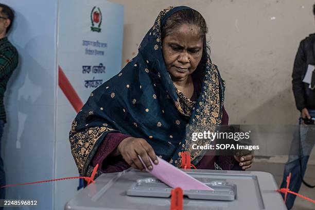 Woman casts her vote into a ballot box at a polling during a mock voting exercise at Sher-e-Bangla Nagar Government Girls High School. The Election...