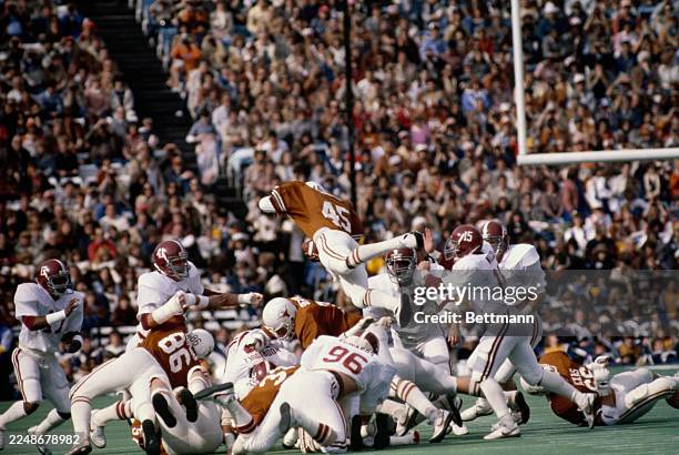 The Texas Longhorns' John Walker leaps over the Alabama Crimson Tide defence for a 2nd quarter first down during the Cotton Bowl in Dallas, Texas,...