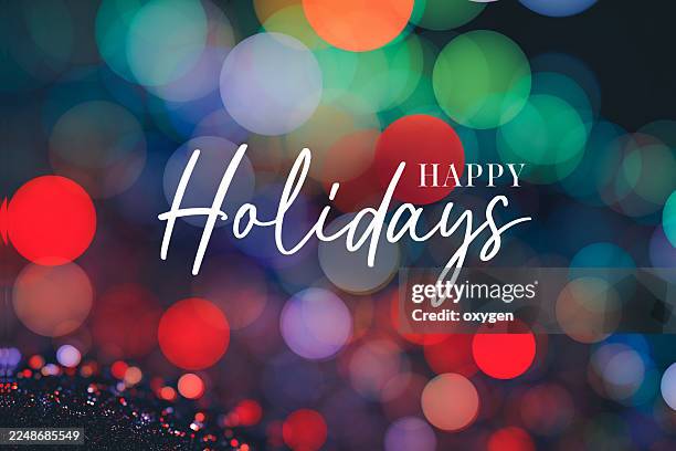 happy holidays christmas calligraphy script text. christmas glitter blured bokeh light background. christmas holiday - happy holidays stock pictures, royalty-free photos & images