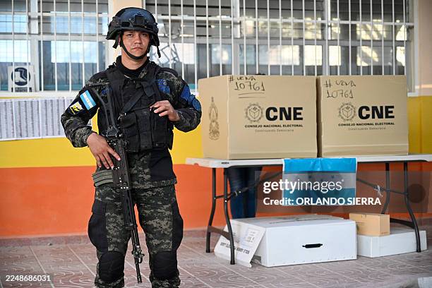 Honduran army soldier guards during Honduras' general election at a polling station in Tegucigalpa on November 30, 2025. Hondurans voted for...