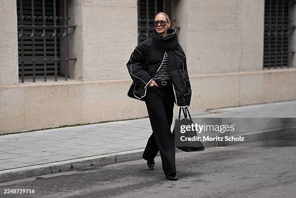 Mirja Klein is seen wearing a black quilted jacket with an oversized boxy silhouette, dropped shoulders, large front flap pockets and contrasting...