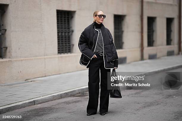 Mirja Klein is seen wearing a black quilted jacket with an oversized boxy silhouette, dropped shoulders, large front flap pockets and contrasting...