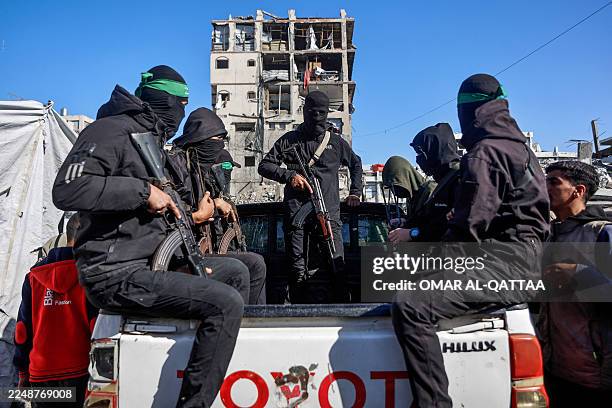 Palestinian Hamas militants arrive to secure the area as Egyptian workers accompanied by members of the International Committee of the Red Cross ,...