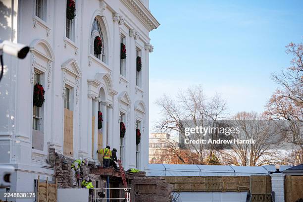 Construction workers take down material where the East Wing used to connect to the White House on December 1, 2025 in Washington, DC. The demolition...