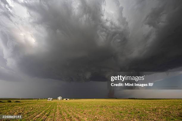 fully condensed tornado, a rotating column of air reaching to the ground, a defined shape - extreme weather stock pictures, royalty-free photos & images