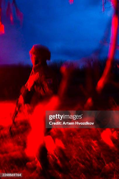 soldier silhouette standing in abstract red blue battlefield atmosphere - special forces stock pictures, royalty-free photos & images