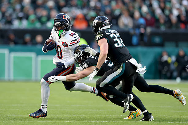 Luther Burden III of the Chicago Bears runs the ball against Cooper DeJean of the Philadelphia Eagles during the second quarter in the game at...