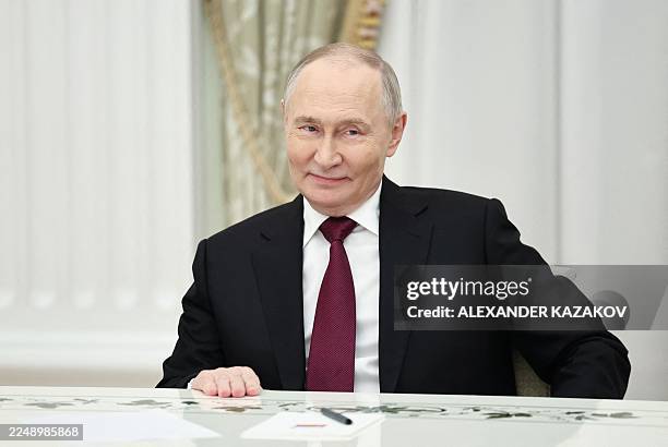 In this pool photograph distributed by the Russian state agency Sputnik, Russia's President Vladimir Putin attends a meeting with US special envoy...