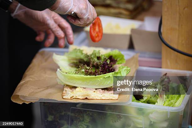 chef cooking freshly focaccia sandwich with ham, cheese, tomatoes and green salad - making a sandwich stock pictures, royalty-free photos & images
