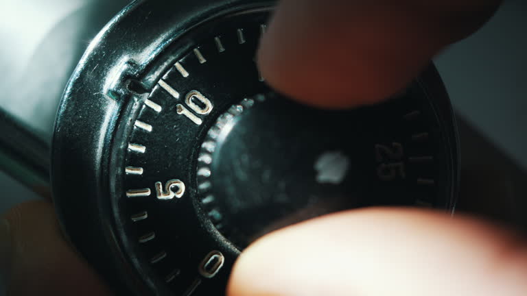 https://media.gettyimages.com/id/2249019075/video/trying-to-unlock-a-rotary-combination-lock-under-a-dim-beam-of-light.jpg?b=1&s=640x640&k=20&c=9nJkvkP8j7DTmTTGgrzA4pqLNtVMksNzoKXFPFM5kvM=