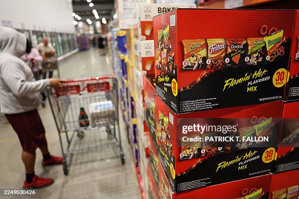 Boxes of PepsiCo's Frito-Lay Flamin' Hot flavored snacks including Cheetos, Fritos, Doritos tortilla chips, and Funyuns are displayed alongside...