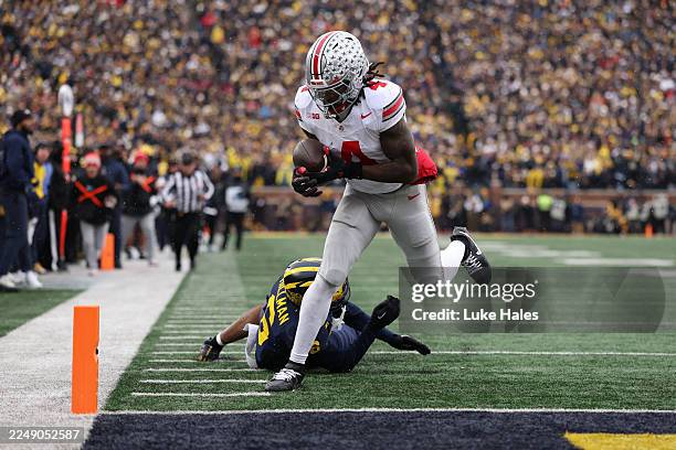 Jeremiah Smith of the Ohio State Buckeyes runs for a touchdown during the second quarter against the Michigan Wolverines at Michigan Stadium on...