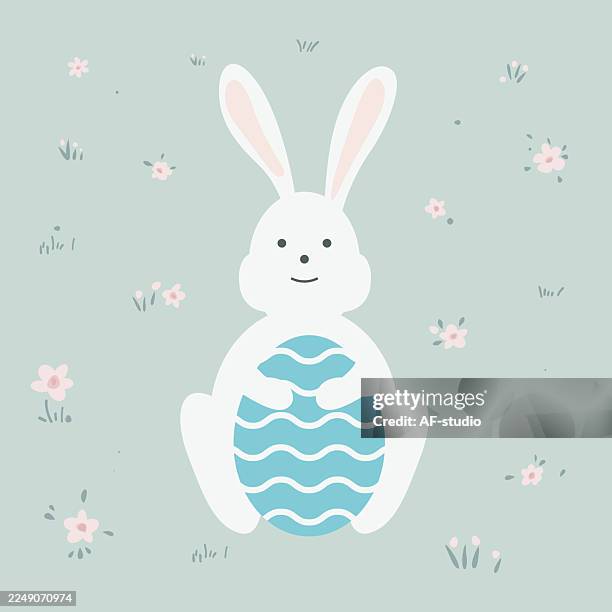 cute flat design easter bunny holding decorated egg - easter bunny ears stock illustrations