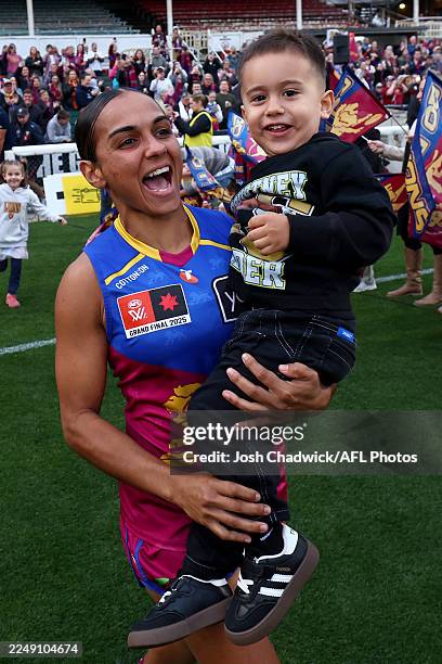 Courtney Hodder of the Lions runs out onto the field with family during the AFLW Grand Final match between North Melbourne Kangaroos and Brisbane...