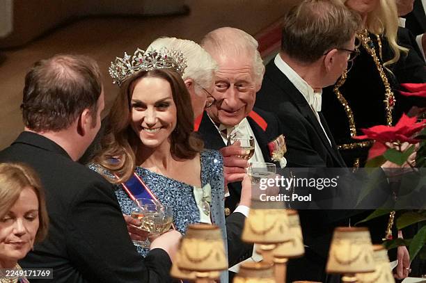 King Charles III, Germany's President Frank-Walter Steinmeier and Catherine, Princess of Wales toast their glasses after the King delivered a speech...