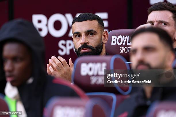 Mohamed Salah of Liverpool applauds from the bench during the Premier League match between West Ham United and Liverpool at London Stadium on...