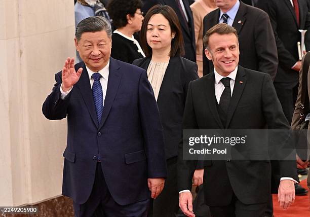 French President Emmanuel Macron and Chinese President Xi Jinping walk during a state visit at the Great Hall of the People on December 4, 2025 in...