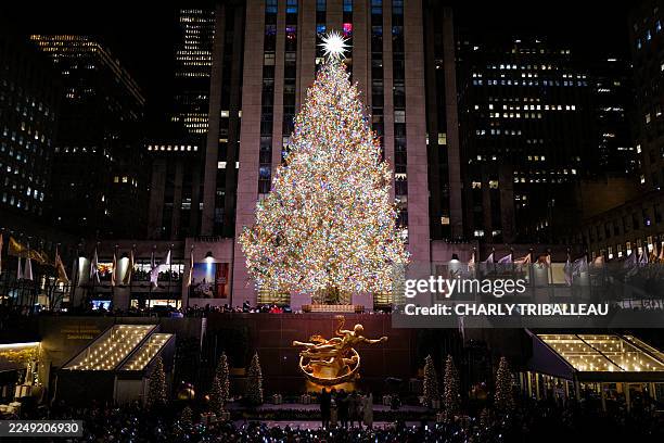 The Christmas tree stands illuminated moments after being lit during the Rockefeller Center Christmas Tree Lighting in New York City on December 3,...