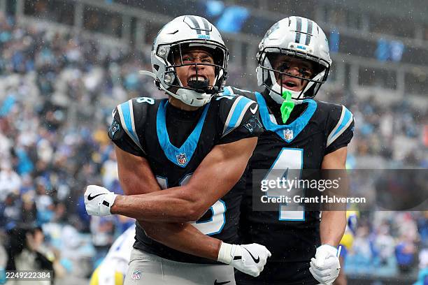 Jalen Coker and celebrates a touchdown with Tetairoa McMillan of the Carolina Panthers during the third quarter against the Los Angeles Rams at Bank...