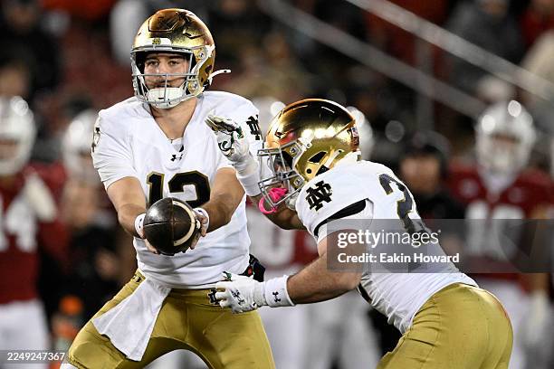 Carr of the Notre Dame Fighting Irish hands off to Aneyas Williams against the Stanford Cardinal in the second quarter at Stanford Stadium on...