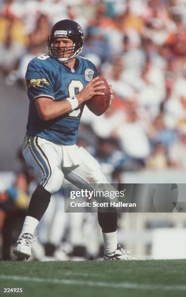 Quarterback Mark Brunell of the Jacksonville Jaguars looks down field for an open receiver while dropping back to pass during the Jaguars 16-17 loss...