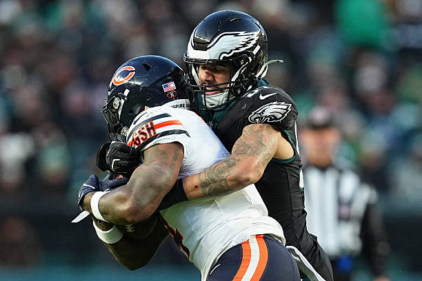Zack Baun of the Philadelphia Eagles tackles D'Andre Swift of the Chicago Bears at Lincoln Financial Field on November 28, 2025 in Philadelphia,...