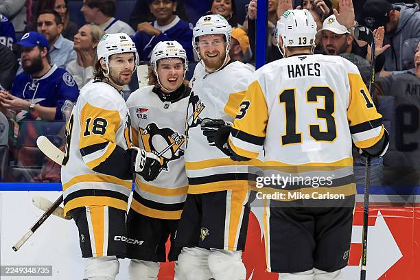 Ville Koivunen of the Pittsburgh Penguins, second from left, celebrates his goal against the Tampa Bay Lightning with Tommy Novak, Anthony Mantha and...
