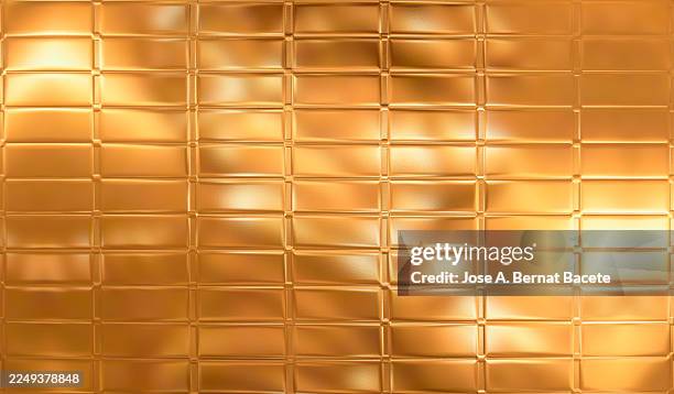 abstract background, gold sheet divided into rectangular tablets. - solid gold stock pictures, royalty-free photos & images