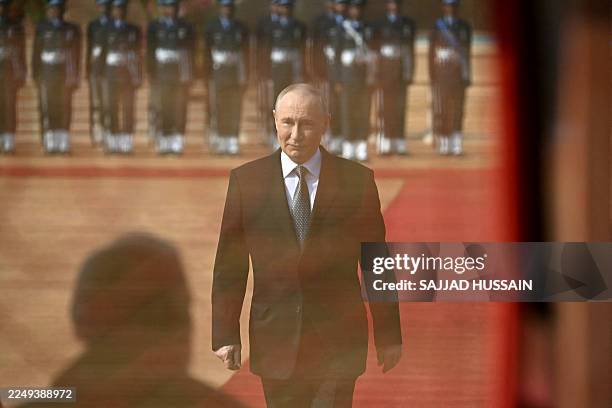 Russia's President Vladimir Putin inspects a guard of honour during his ceremonial reception at India's presidential palace, Rashtrapati Bhavan, in...