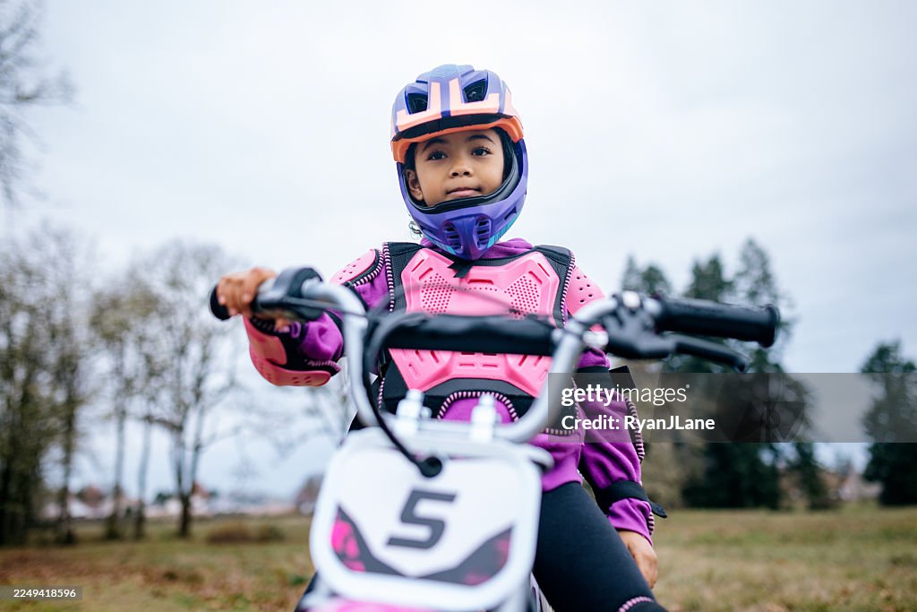 Young Motocross Girl Riding At Park