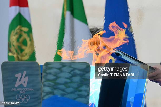 Italy's President Sergio Mattarella lights a cauldron with a torch during the Inauguration ceremony of the Olympic Torch Relay for the Milan-Cortina...