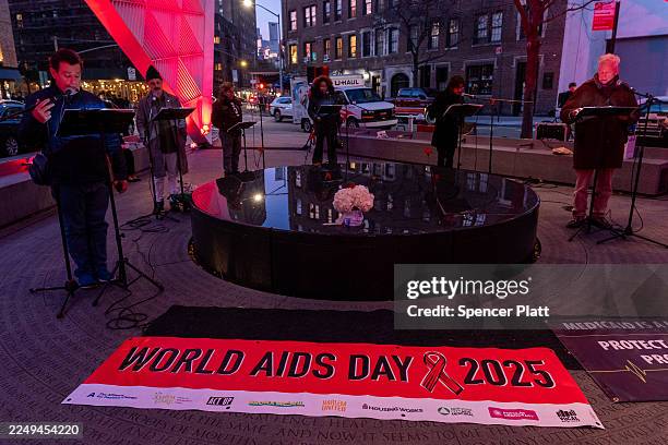 Members of the public participate in the reading of the names of New Yorkers lost to AIDS at the New York City AIDS Memorial in observance of World...