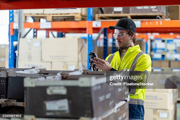warehouse worker using barcode reader in warehouse. - shelf stocker stock pictures, royalty-free photos & images