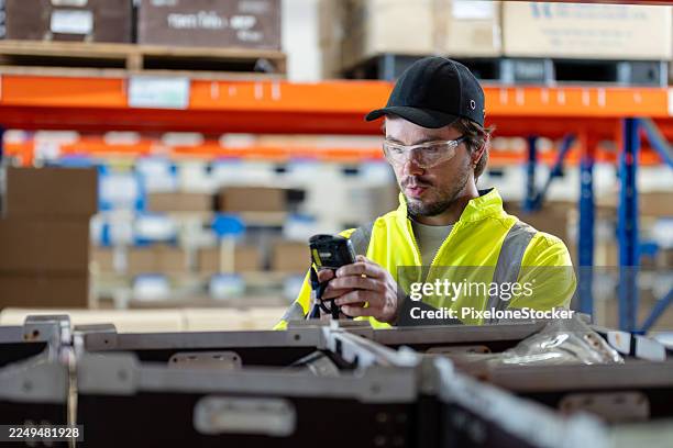 warehouse worker using barcode reader in warehouse. - shelf stocker stock pictures, royalty-free photos & images