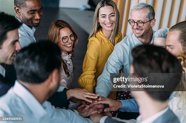 motivating the team. - hand stack stock pictures, royalty-free photos & images