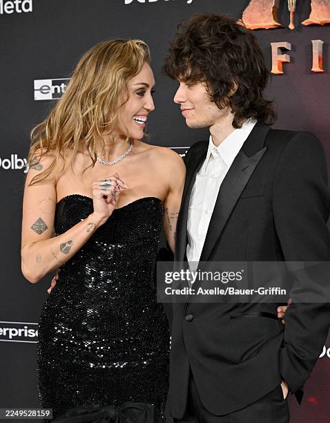 Miley Cyrus and Maxx Morando attend the Global Premiere of 20th Century Studios' "Avatar: Fire and Ash" at Dolby Theatre on December 01, 2025 in...