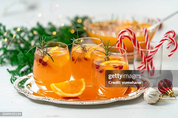 refreshing cranberry christmas punch with pomegranate, orange and rum - punch drink stock pictures, royalty-free photos & images