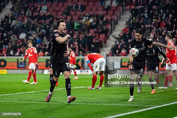 Haris Tabakovic and Kevin Diks of Borussia Moenchengladbach celebrate their teams first goal during the Bundesliga match between 1. FSV Mainz 05 and...